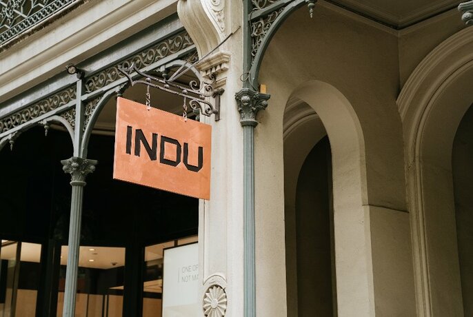 INDU restaurant building facade with classical pillar.