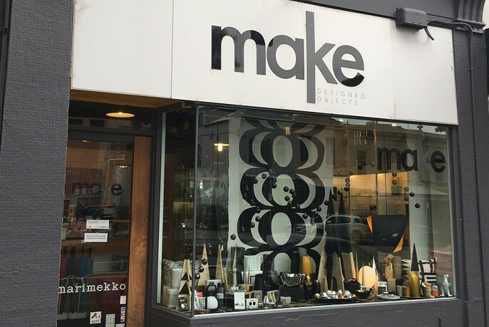 Shopfront window displaying various homewares, with sign showing shop name above