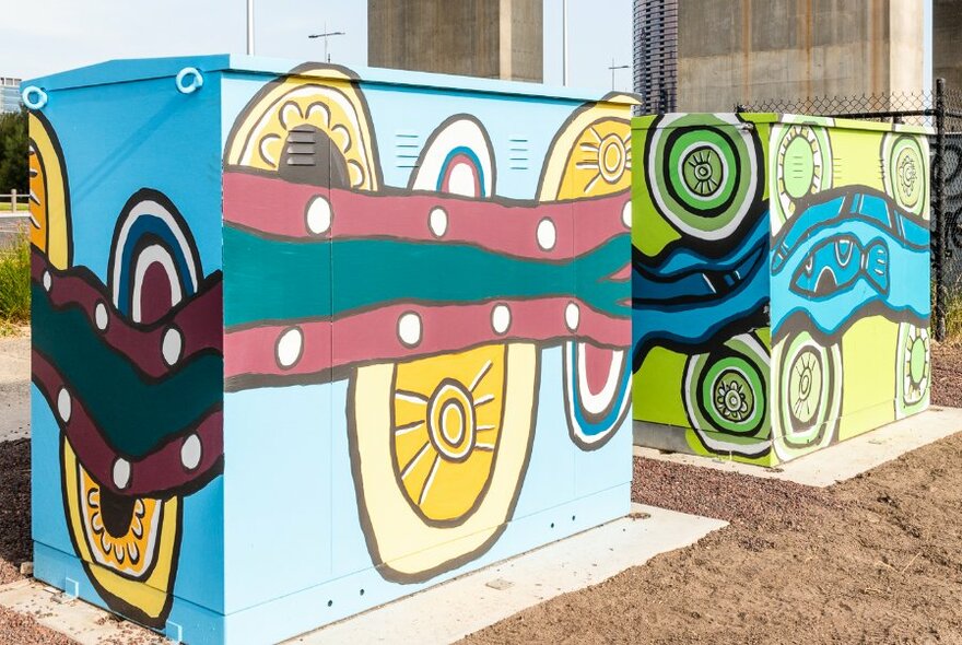 Colourful Aboriginal mural paintings on electrical boxes. 