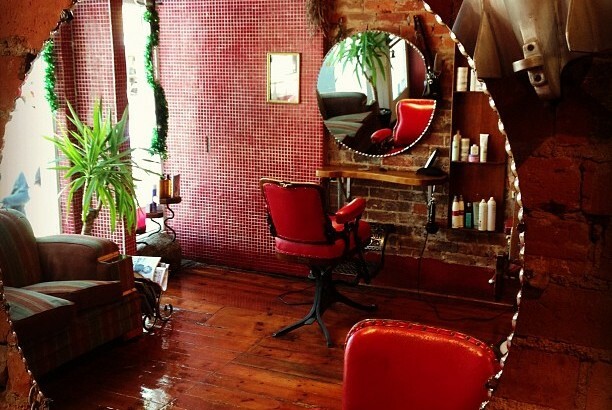 Red barbers chair and mirror at a hairdressers.