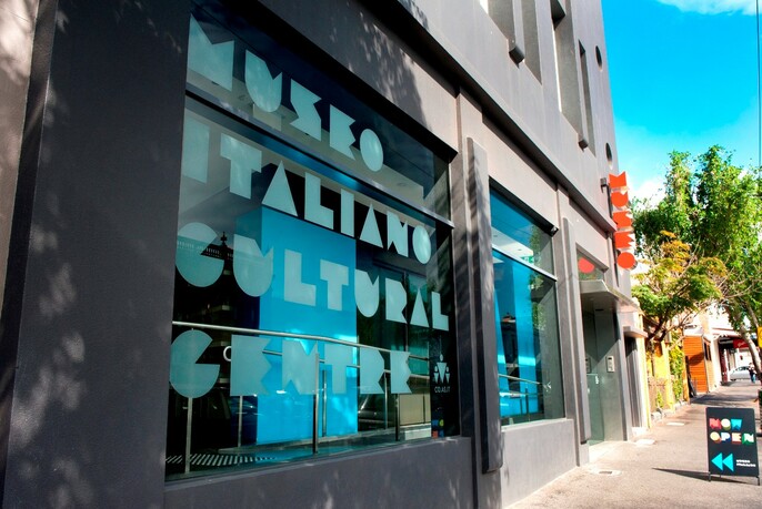 Signage covering front window of Museo Italiano Cultural Centre building.