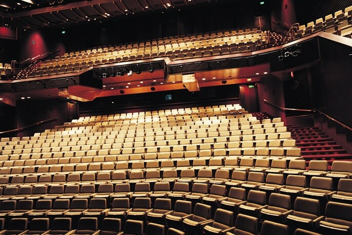 Tiers of theatre seats in the Playhouse, observed from the stage.