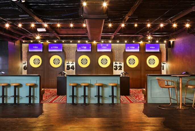 Modern-looking dart boards and bar stools.