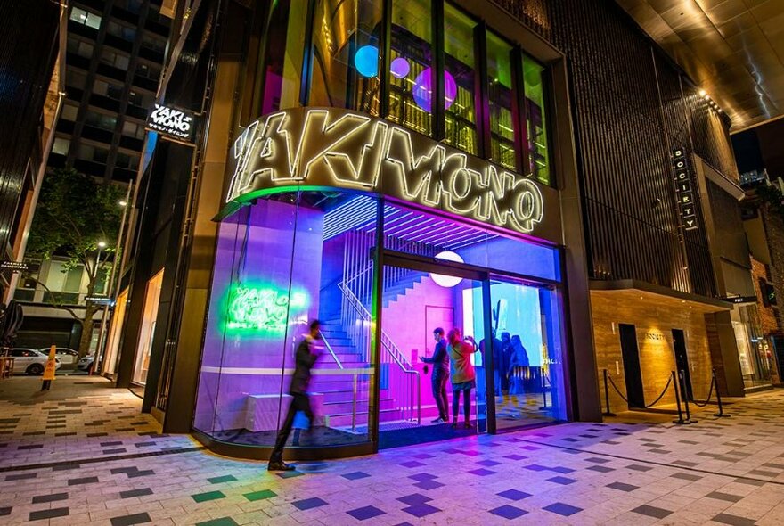 Neon-lit entrance to Yakimono restaurant.