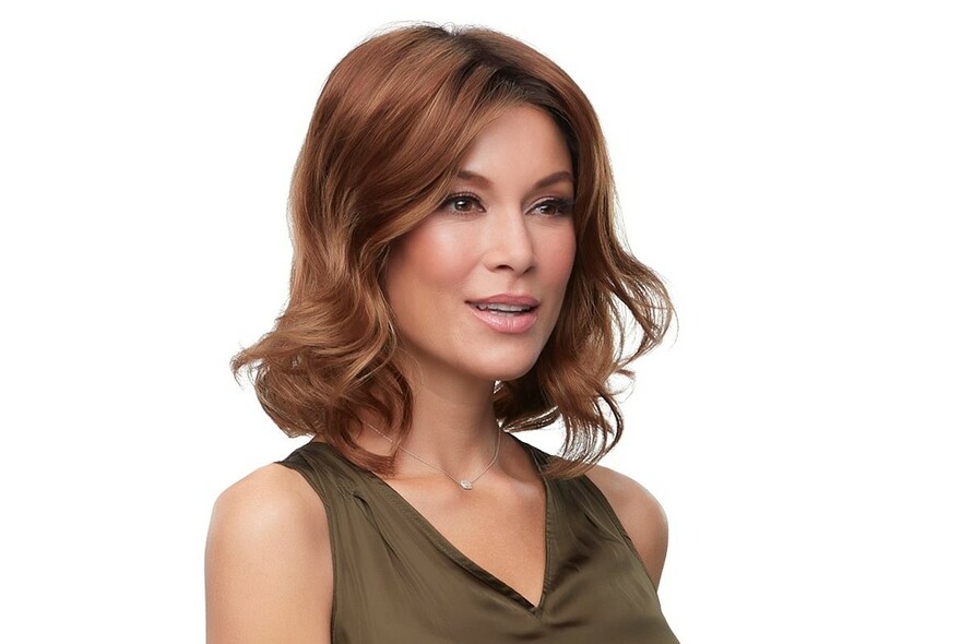 Model wearing slightly wavy shoulder-length light brown wig.
