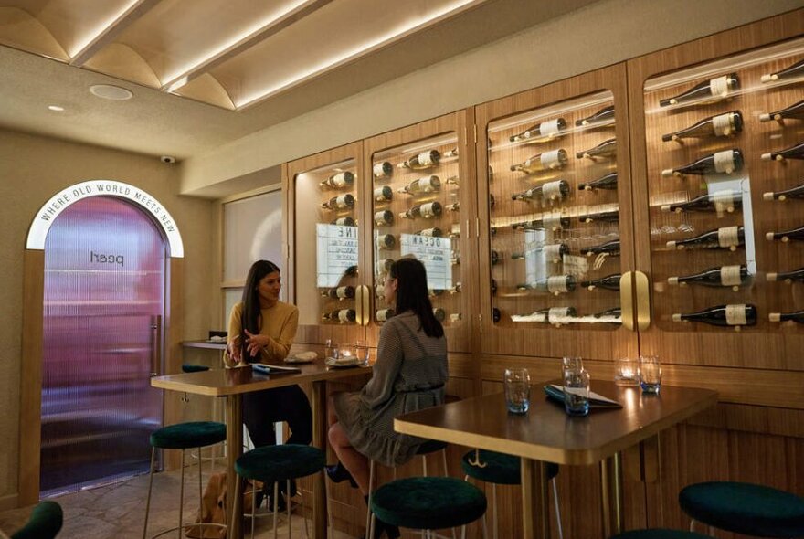 Two women sitting in a French wine bar