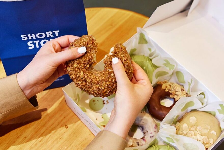 flavoured doughnut being torn in half