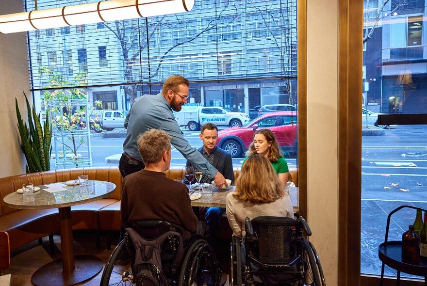 People dining in a restaurant by the window. 