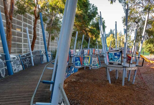 A walkway at a children's playground covered with paintings. 