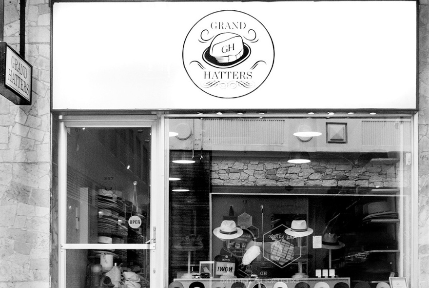 Hat store exterior with signage and window displaying a range of hats.