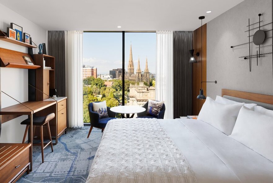 A hotel room overlooking the city skyline. 