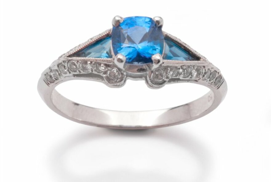 A diamond and saphhire ring in a highly decorative setting.