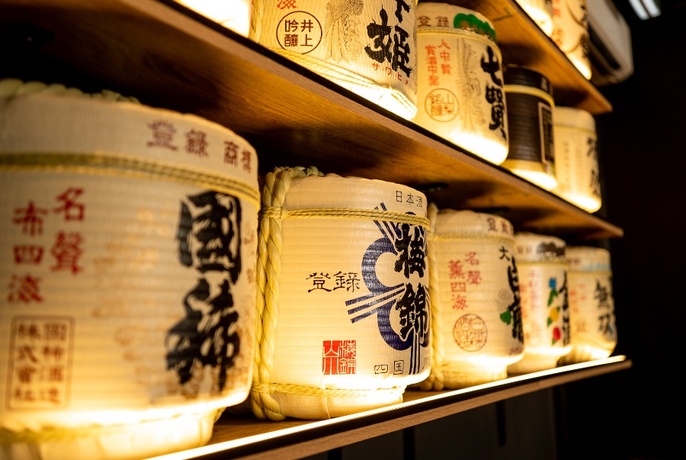 Sake barrels on shelf.