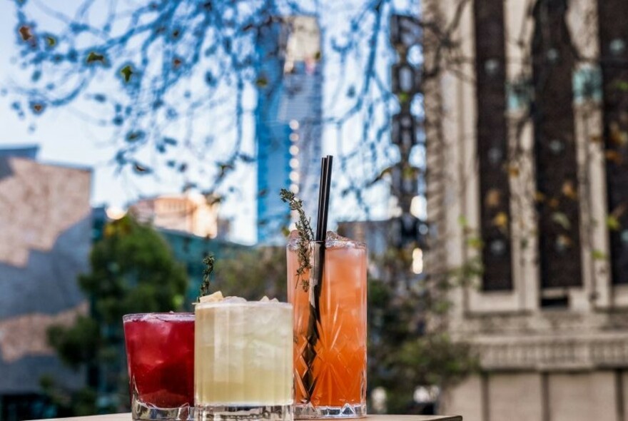 Coloured drinks and city buildings.