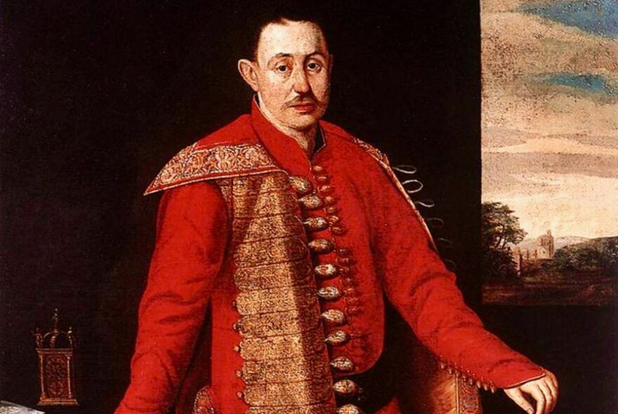 Oil painting of a man wearing an elaborate red coat with gold embossing and buttons, dating from the mid-1600s.