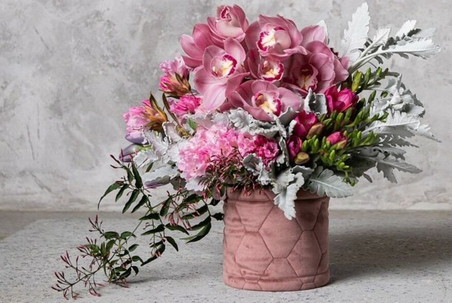 Floral arrangement in a pink pot.
