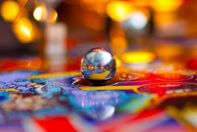 Close up of a pin ball inside a pinball machine.