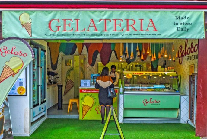 A customer in a brightly coloured ice cream shop.