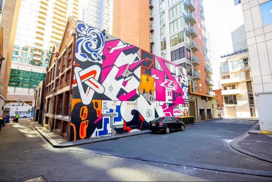 The side of a building painted with bright bold graffiti art. 