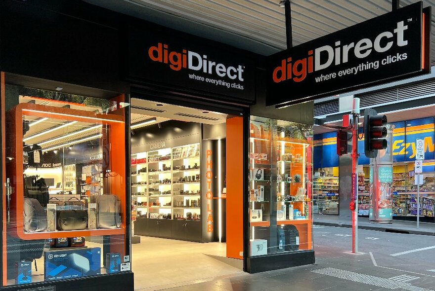 digiDirect street view looking into shop interior with backlit shelves.
