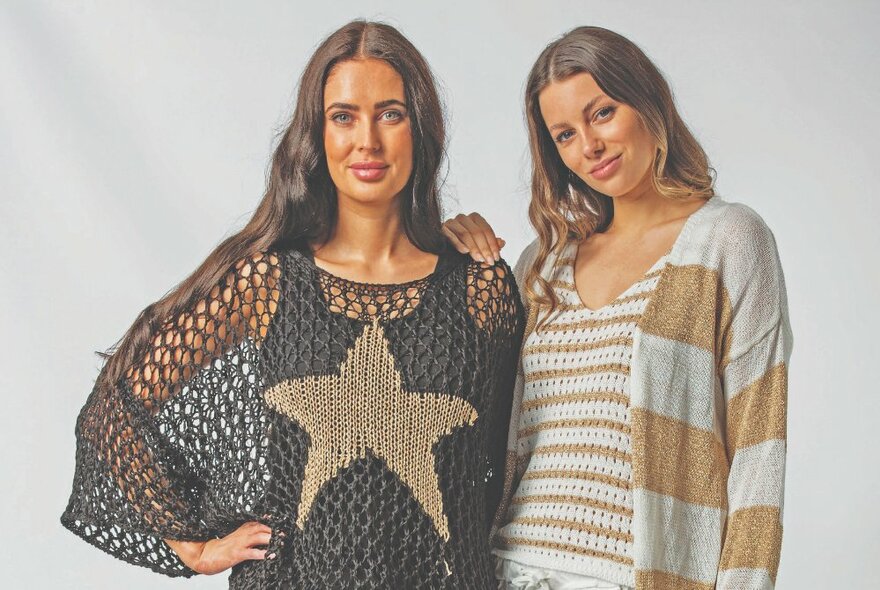 Two models with long hair wearing loose knitwear featuring stripes and star.