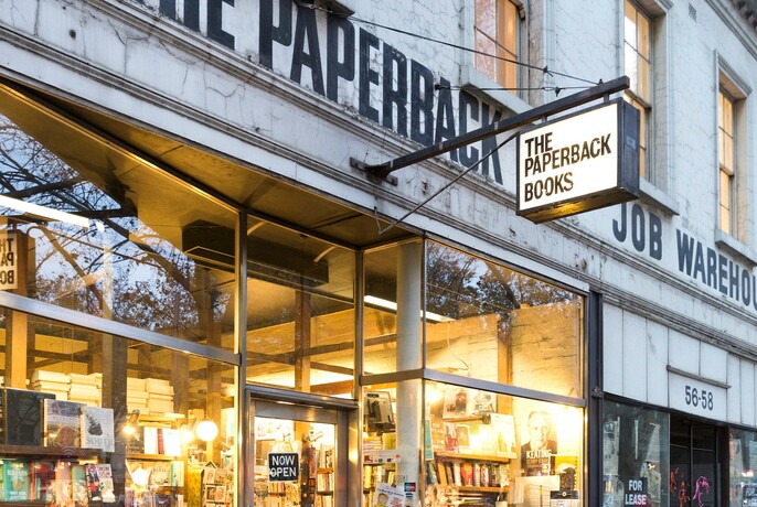 Exterior of The Paperback Bookshop at twilight.