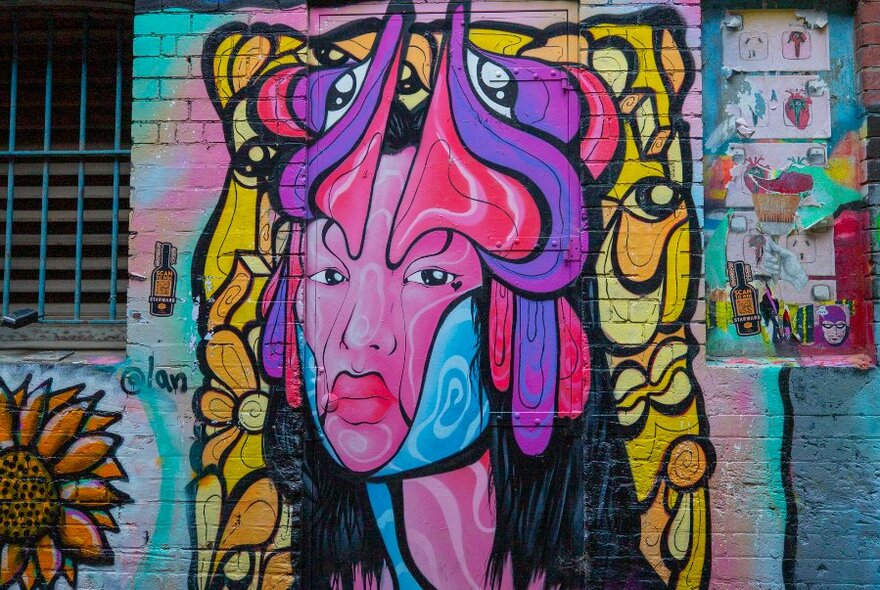 A street art mural of a woman's face. 