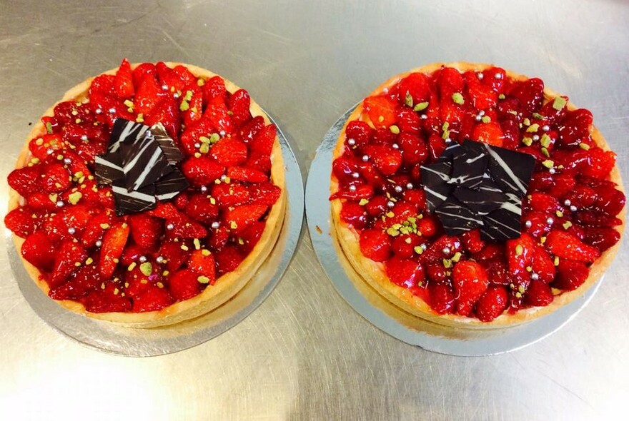Two round sponge cakes topped with strawberries.