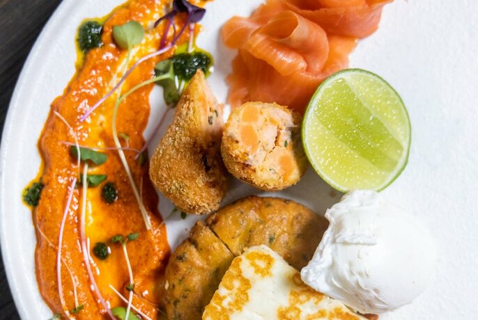 A salmon dish on a white plate with sauce