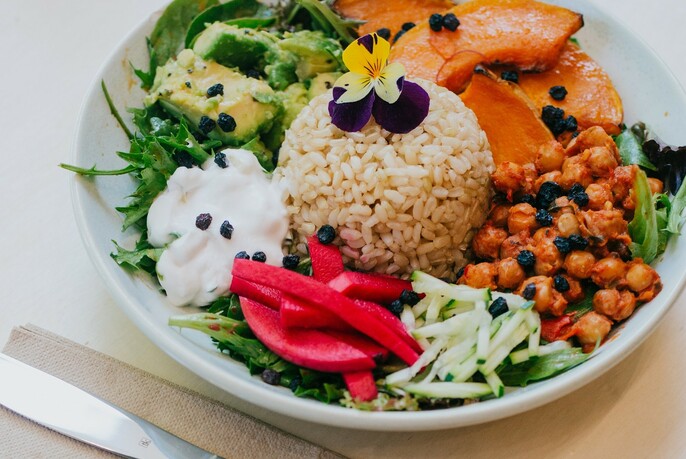 A rice bowl with avocado, pumpkin and chickpeas.