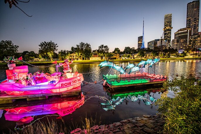 A Christmas art installation floating on the Yarra River, with the city in the background.