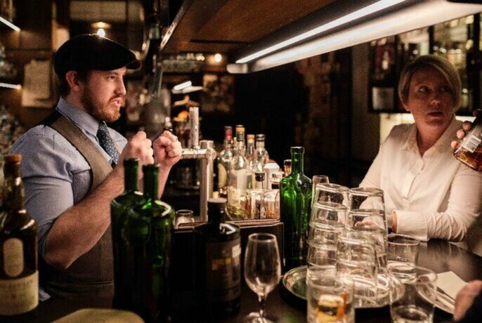 Barman serving a customer.