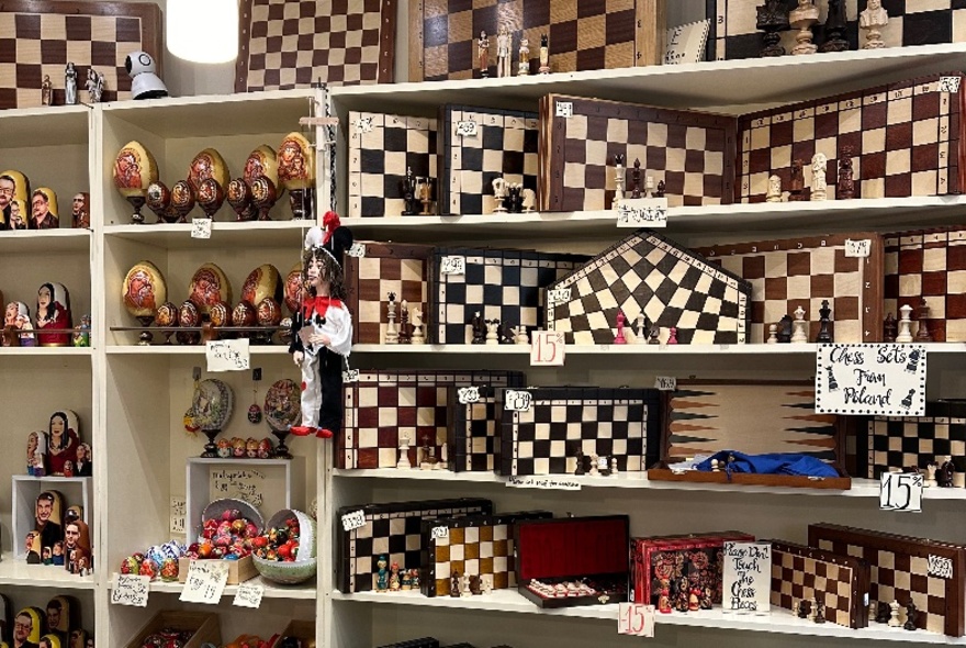 Retail store shelves displaying Eastern European nesting matryoskha dolls and chess sets.