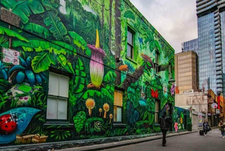A large green floral street art mural