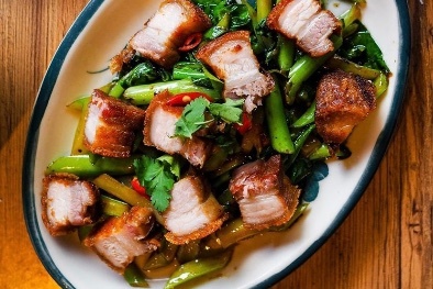 A Thai pork belly dish with greens.