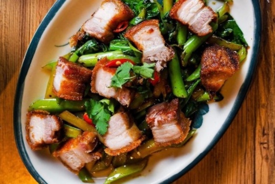 A Thai pork belly dish with greens.