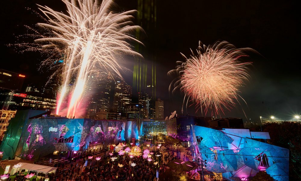 Fireworks over Fed Square at night.