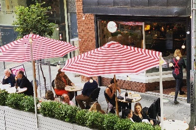 Red and white umbrellas outside a restaurant.