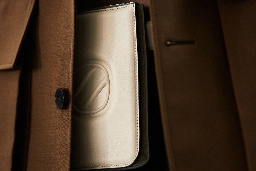 Brown jacket detail and leather wallet.