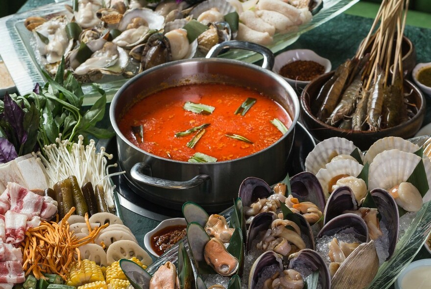 Hot pot surrounded by seafood