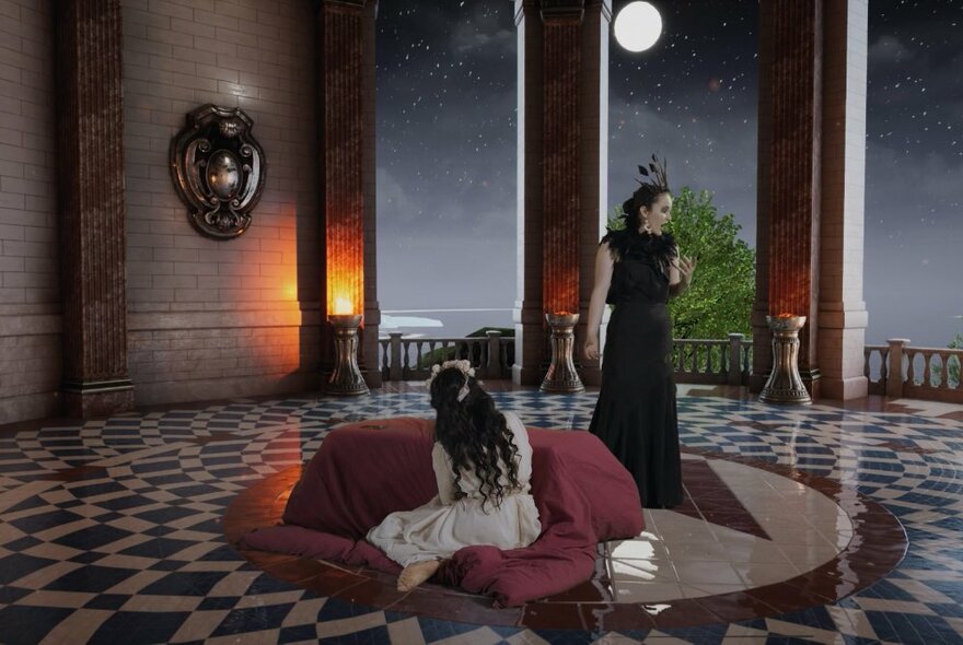 Two performers on a stage, on a covered portico  with a full moon visible in the night sky between two columns.