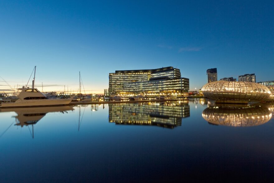 A view of Docklands taken from the Yarra River at dusk with everything reflected back on the water. 