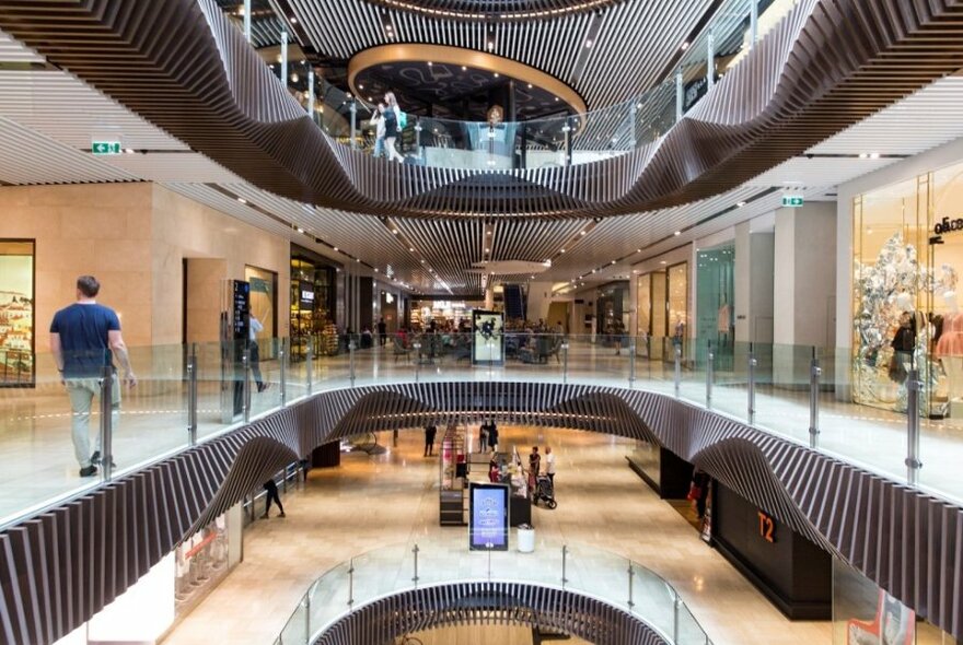 A view of several levels of Emporium Melbourne shopping centre with geometric architecture.