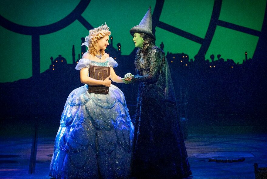 Glinda the 'Good' Witch and Elphaba the 'Evil' Witch on stage during a scene from WICKED the Musical.
