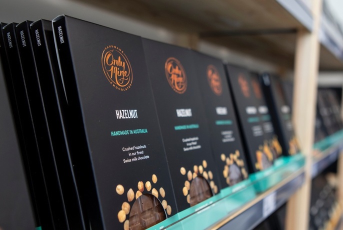 Rows of chocolate bars lined up on a shelf.