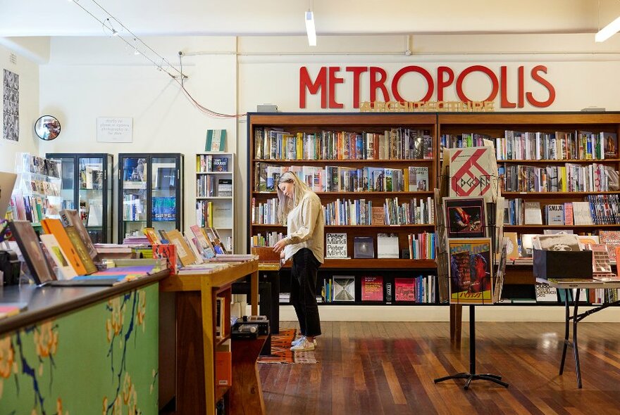 A woman browsing in a book shop.