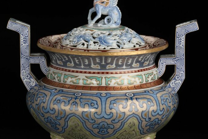 Highly decorated and patterned porcelain incense burner dating from the nineteenth century, set against a black background.