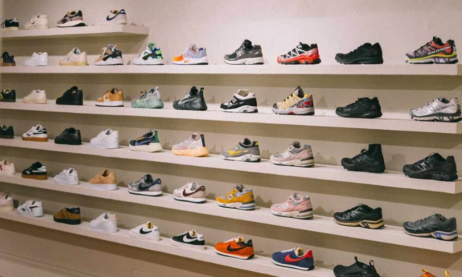 Sneakers displayed on a row of white shelves