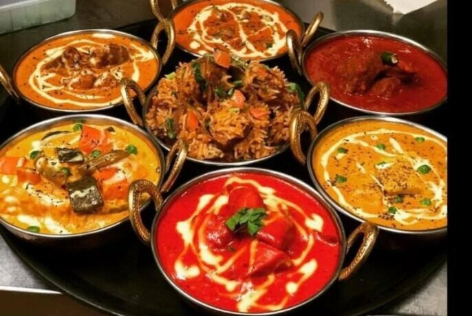 Brightly-coloured bowls of Indian curry.