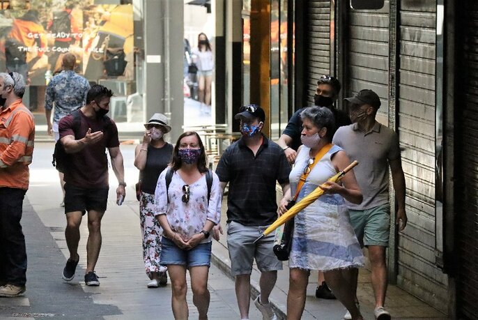 People wearing face masks on a small group walking tour of the city.